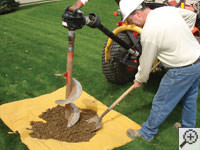 Auguring a hole in the earth for a foundation repair in Perryton