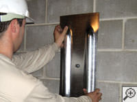 Mounting a foundation wall plate for an earth anchor installation in Odessa.