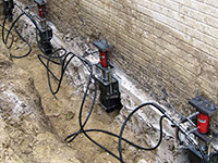 Using foundation push piers to lift a foundation during a repair in Canyon.