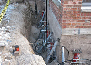 Foundation push piers installed around a house with a foundation settlement issues in Stinnet