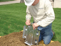 Fastening an earth anchor for a severely bowing wall in Dumas.