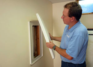 Foundation wall anchor covers installed in a finished basement with a repaired foundation wall in Stinnet.