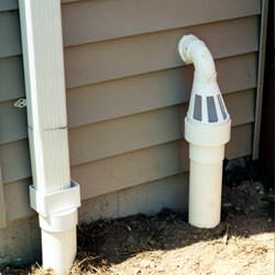 A grated sump pump discharge line fitting in Candian