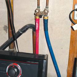 Washer hoses in a basement  in Stratford